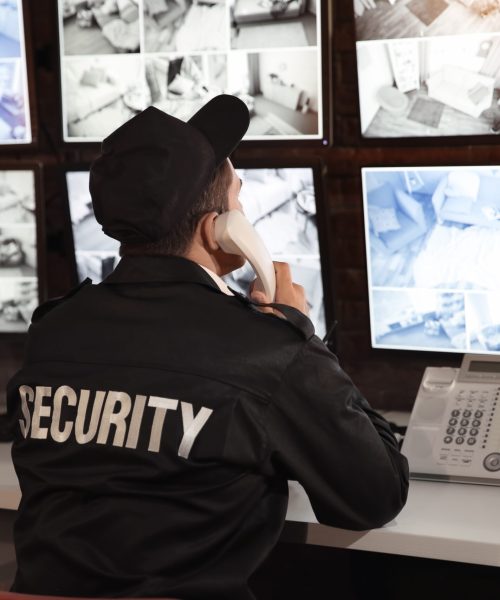 Male,Security,Guard,Talking,By,Telephone,In,Surveillance,Room Male,Security,Guard,Talking,By,Telephone,In,Surveillance,Room